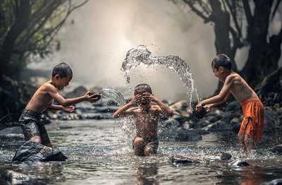 Children playing in river with joy